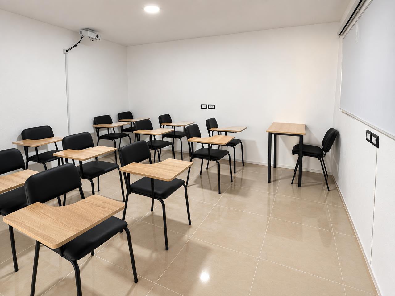 Training room with writing-arm chairs and a ceiling projector